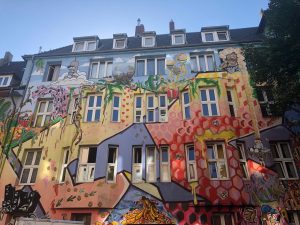 Colorful painted apartment building covered in art