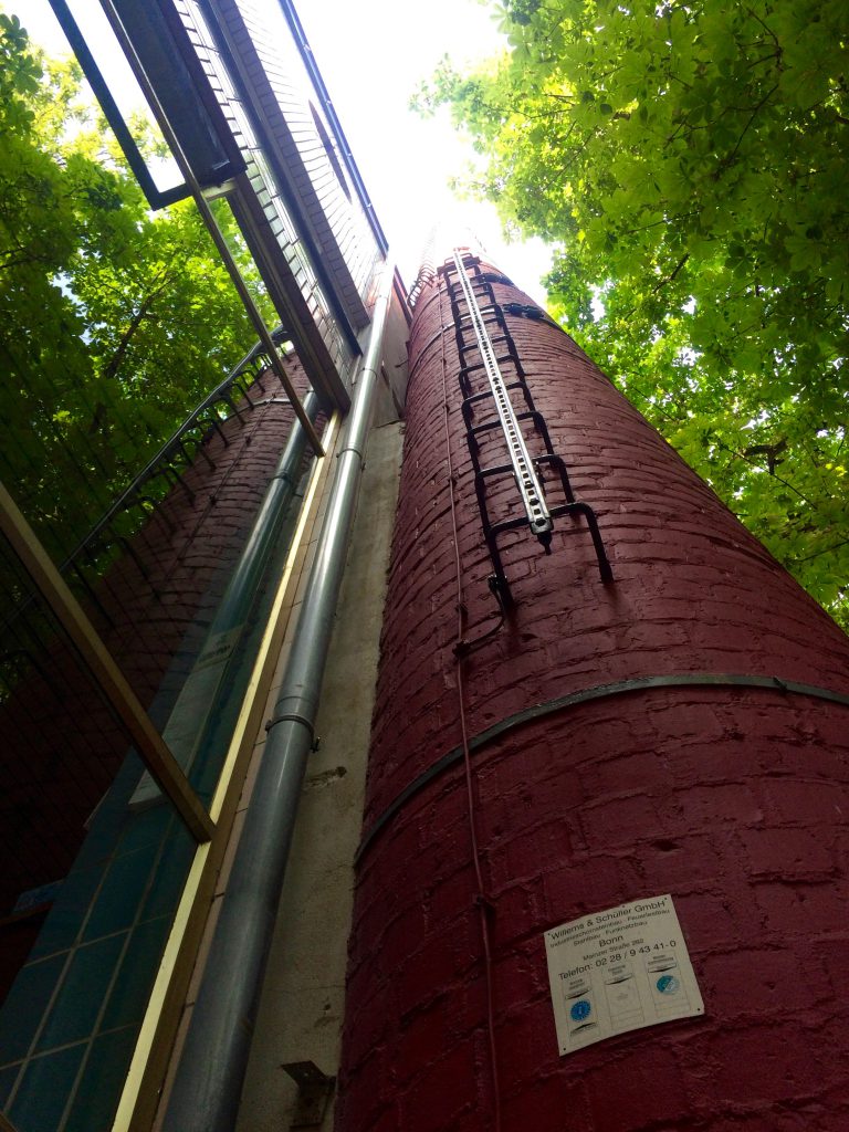 Red brick chimney viewed from the base at Paeffgen, Cologne