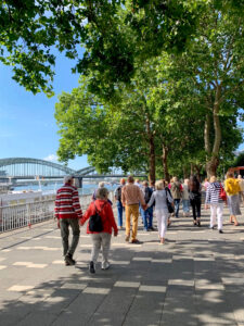 Tour group walks along the riverbank in Cologne