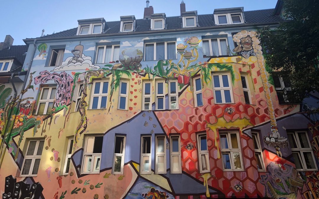 Colorful painted apartment building covered in art