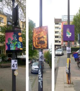 Three lampposts displaying art in the Belgian Quarter, Cologne