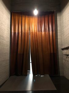 Hallway within the Kolumba Museum with a large leather curtain