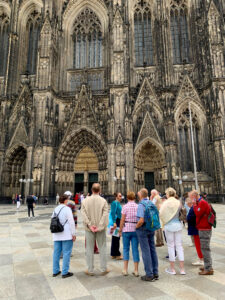 Walking tour group stands outside the main entrance of the Cologne Cathedral